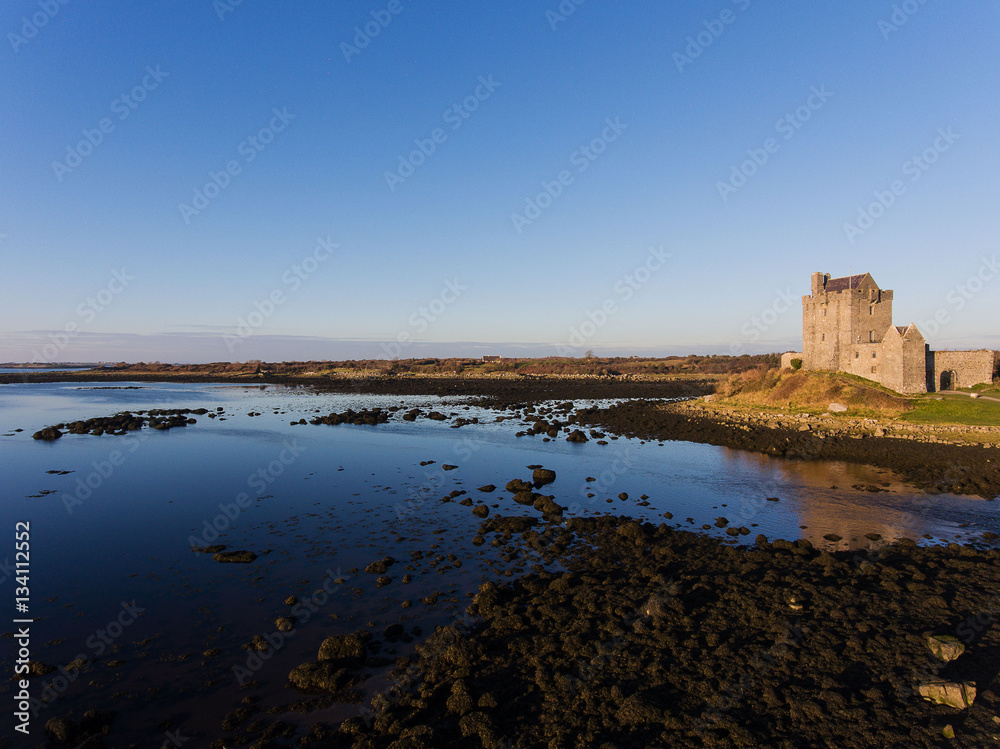 Aerial Dunguaire Castle Evening Sunset, near Kinvarra in County Galway, Ireland - Wild Atlantic Way Route. Famous public tourist attraction in Ireland. Aerial Dunguaire Castle Evening Sunset, near Kinvarra in County Galway, Ireland - Wild Atlantic Way Route. Famous public tourist attraction in Ireland.