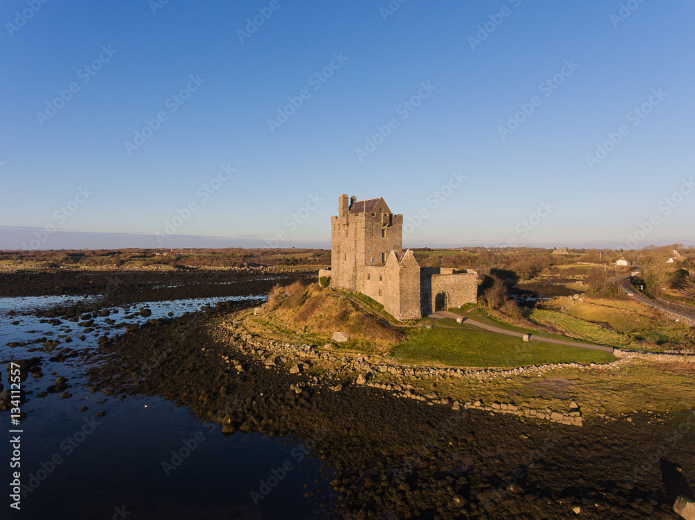 Aerial Dunguaire Castle Evening Sunset, near Kinvarra in County Galway, Ireland - Wild Atlantic Way Route. Famous public tourist attraction in Ireland.