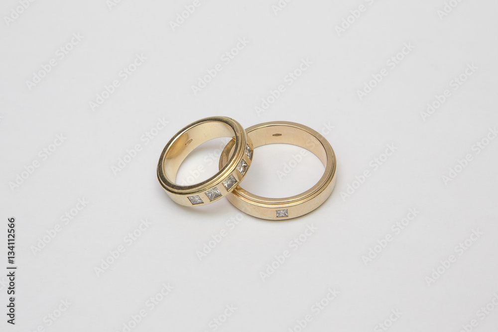 Yellow gold wedding rings with diamonds isolated on white Yellow gold wedding rings with diamonds isolated on white