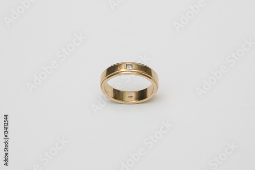 Yellow gold wedding ring with diamonds isolated on white
