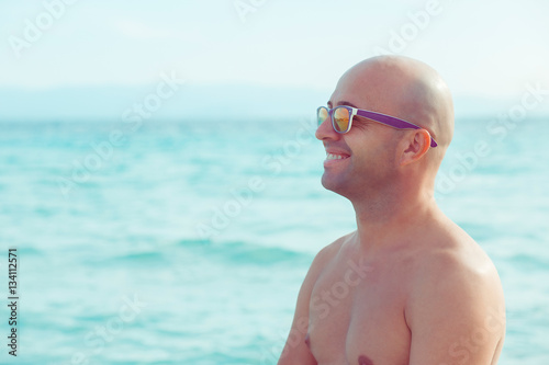 Sexy man by the sea enjoying vacation nature smiling