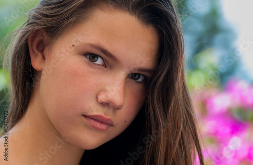 Portrait of a young girl with pink flowers