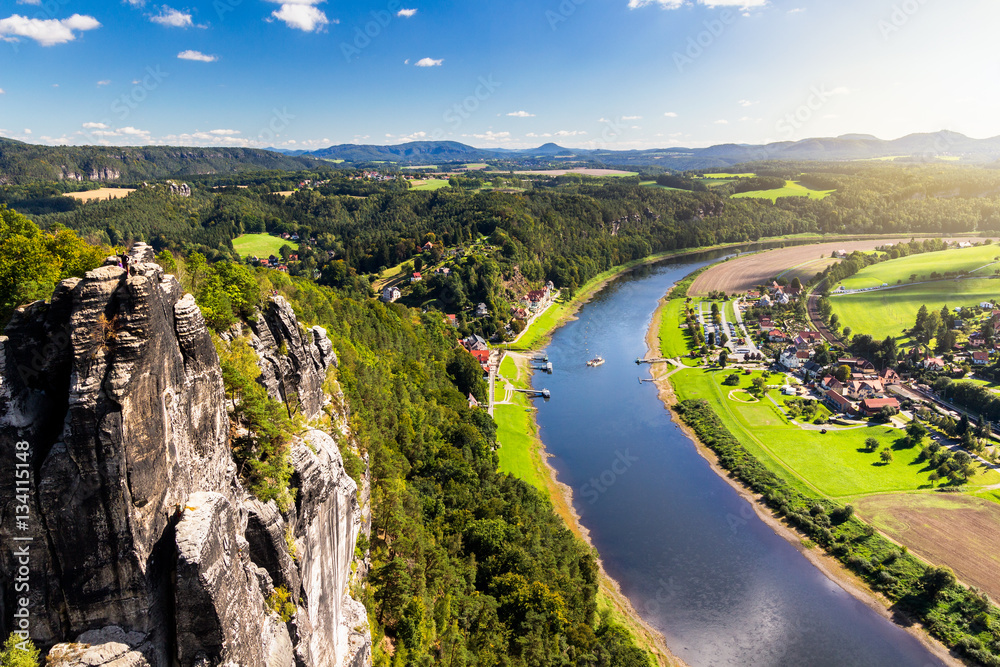 View from viewpoint of Bastei in Saxon Switzerland Germany to the town city and the river Elbe on a sunny day