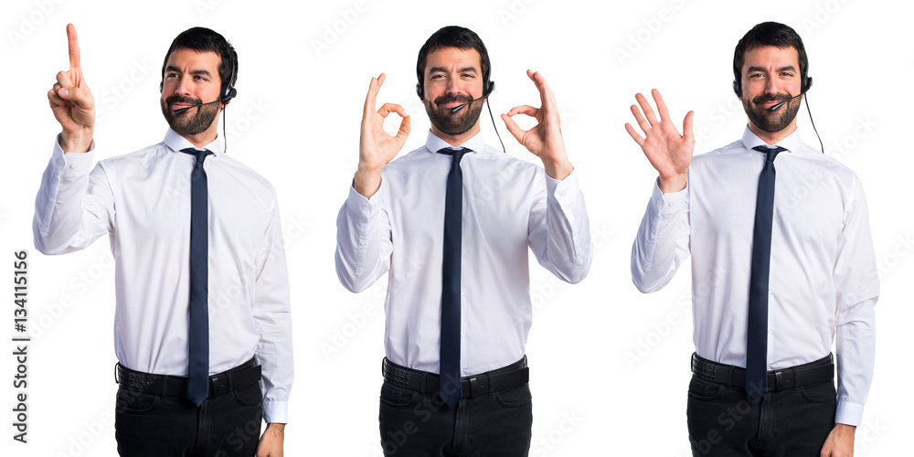 Young man with a headset making OK sign Young man with a headset making OK sign