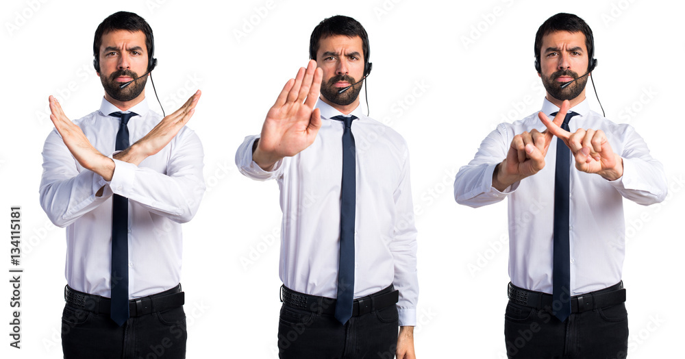 Young man with a headset making stop sign Young man with a headset making stop sign