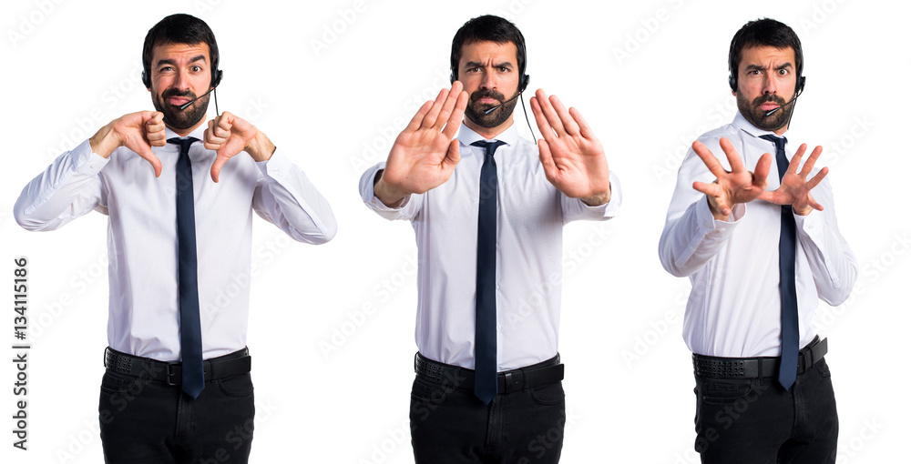 Young man with a headset making stop sign Young man with a headset making stop sign