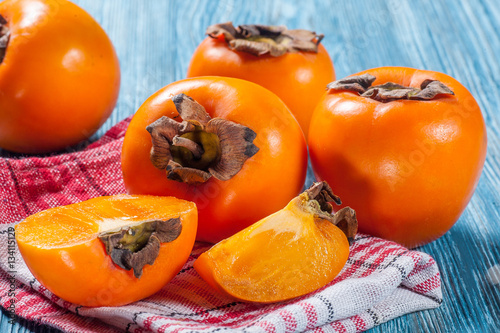 Persimmons on table photo