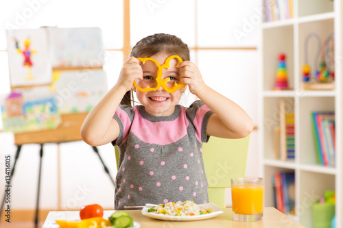 child girl eating vegan foo...