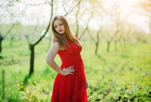 Portrait of light hair girl on red dress background spring garde