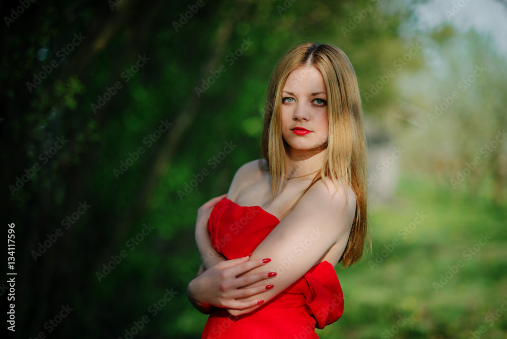 Portrait of light hair girl on red dress background spring garde Portrait of light hair girl on red dress background spring garde