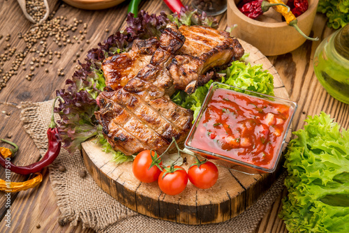 grilled beef steak on the grill on a wooden table
