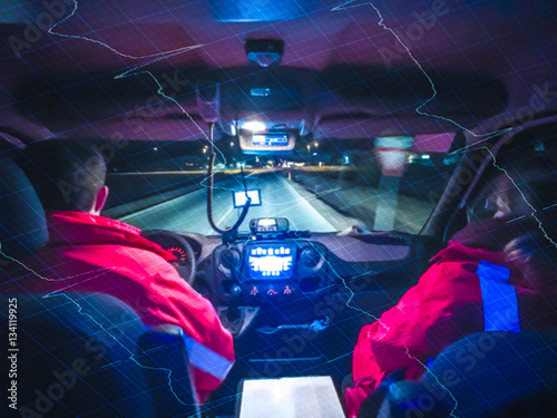 Double exposure of a driving compartment of an ambulance and ECG