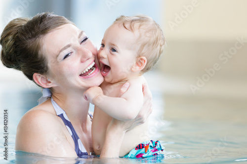 Mother and her newborn child at infant swimming class © Kzenon