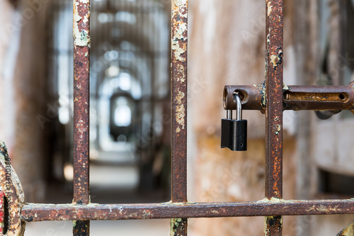Door lock on rusty metal cell in old prison.