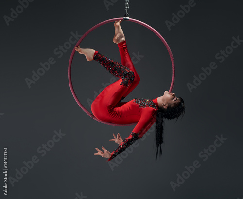 Young slim gymnast with red hoop artistic portrait