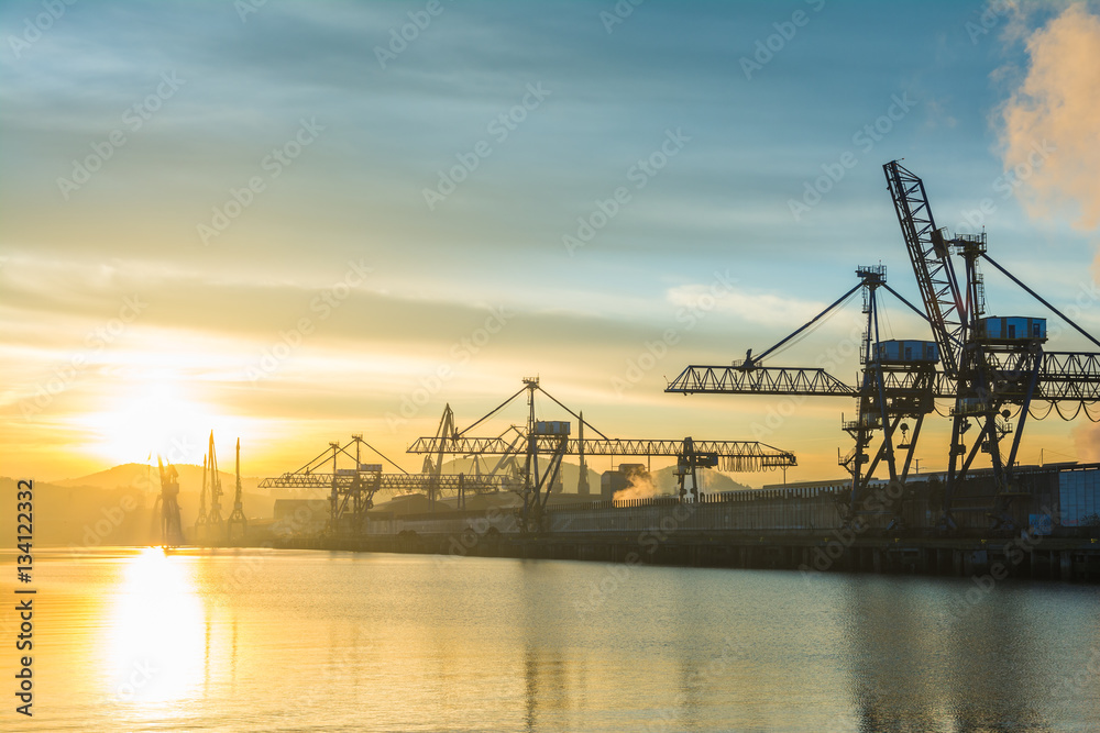 Fototapeta premium sunrise view to Bilbao industrial cranes, spain