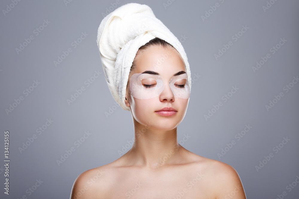 Woman with mask on closed eyes and towel on head Woman with mask on closed eyes and towel on head