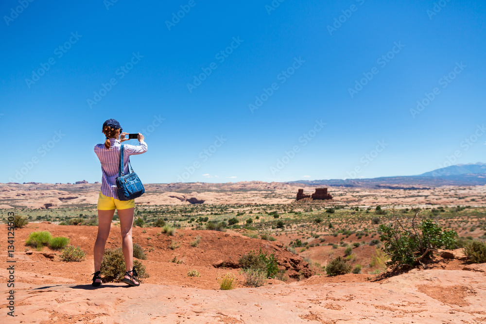 Young woman take pictures at monument valley Young woman take pictures at monument valley