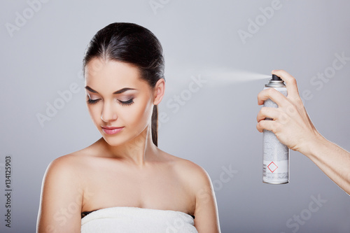 Sprinkling hairspray on girl photo