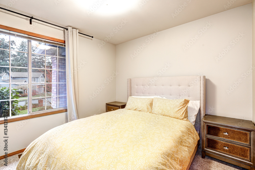 Fototapeta premium Beige bedroom interior features yellow bed