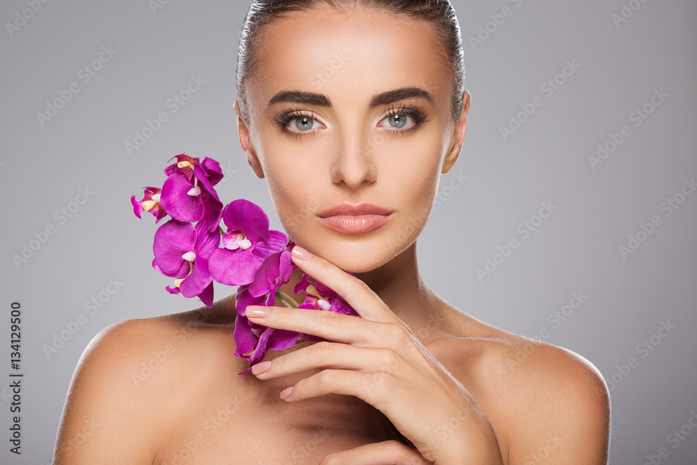 Beauty portrait of woman with purple orchid Beauty portrait of woman with purple orchid