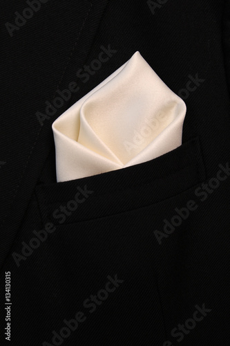 pocket square сreamy-white silk - handkerchief in the breast pocket of a man's wool luxury black suit © oleh91