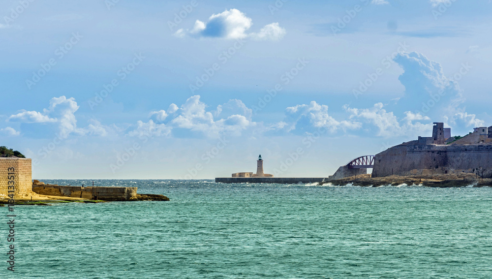 malta impression - lighthouse at the harbor entrance malta impression - lighthouse at the harbor entrance