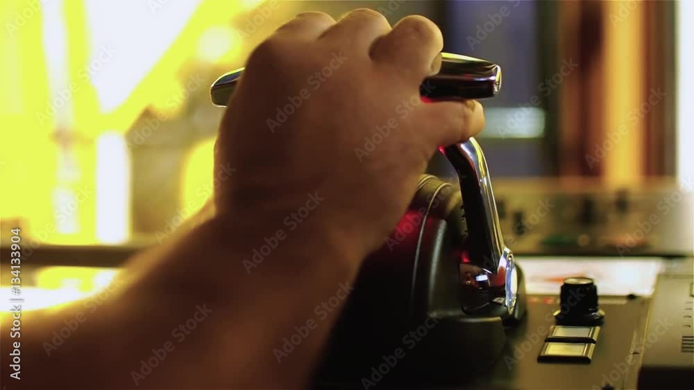 Tug master controls motors. Close-up of hands in a low light