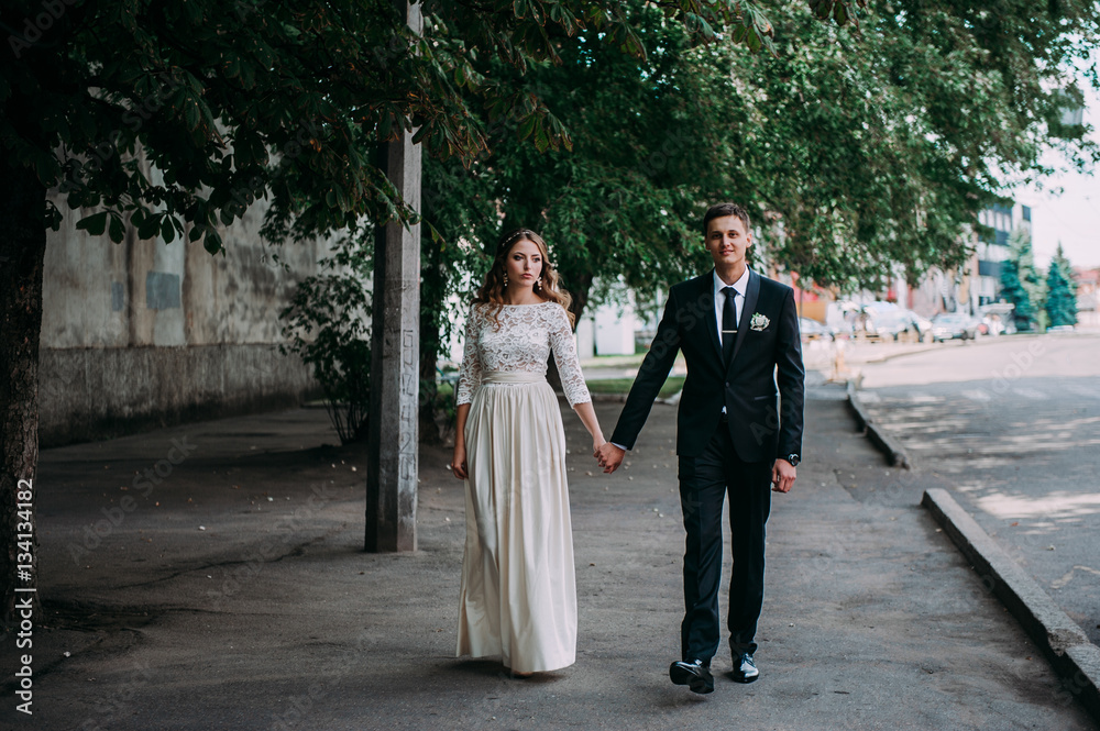 Fototapeta premium happy bride and groom at a park on their wedding day