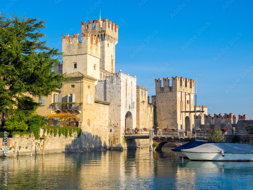 Sirmione fortress with bridge over Garda lake, castle surrounding old town