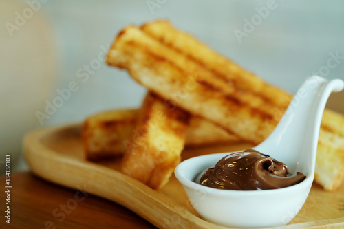 Recipe French Toast Sticks with hazelnut spread on wooden table background