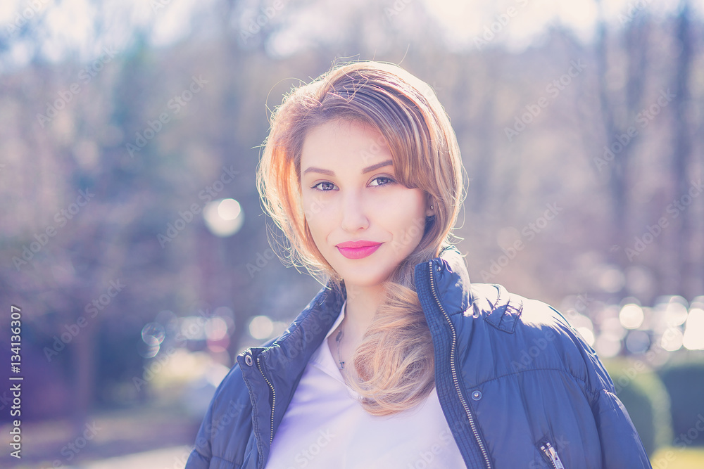 Portrait of woman smiling with perfect smile in a park outdoors background late autumn winter Portrait of woman smiling with perfect smile in a park outdoors background late autumn winter