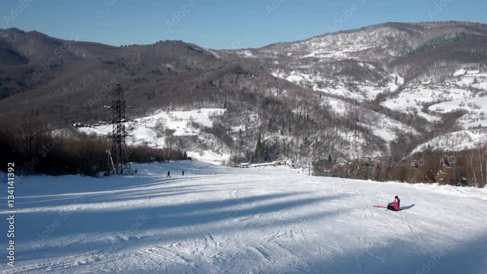 Fast Skier Rides Down the Snowy Slopes on a Pristine Day on the Mountain With Clear Skies and Snowy Trees on the Side