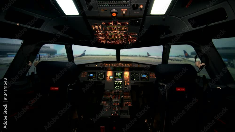 Empty workplace of aircraft pilots. Cockpit or flight deck of a modern passenger airplane with two seats. All is ready to fly. No people. Airbus A319 A320 A321