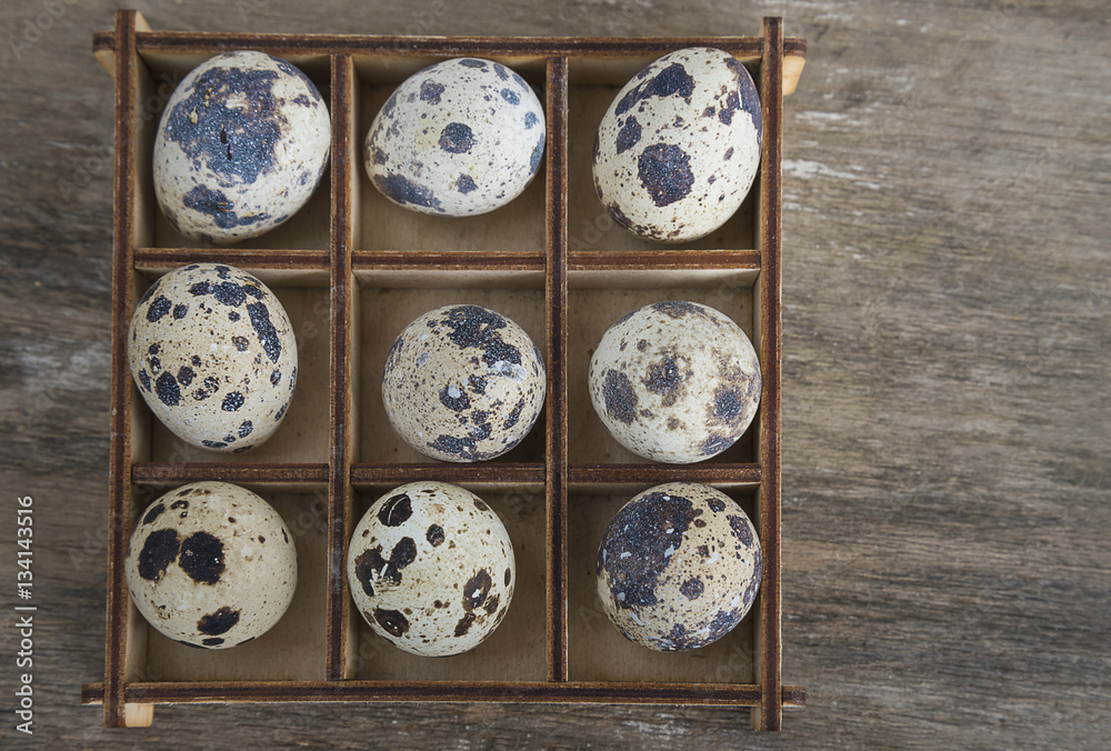 Fototapeta premium easter composition/box with quail eggs on old wooden background