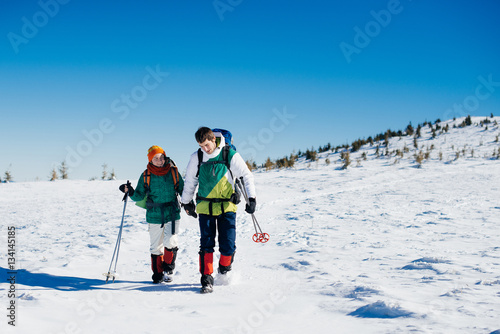 Loving couple traveling in winter mountains