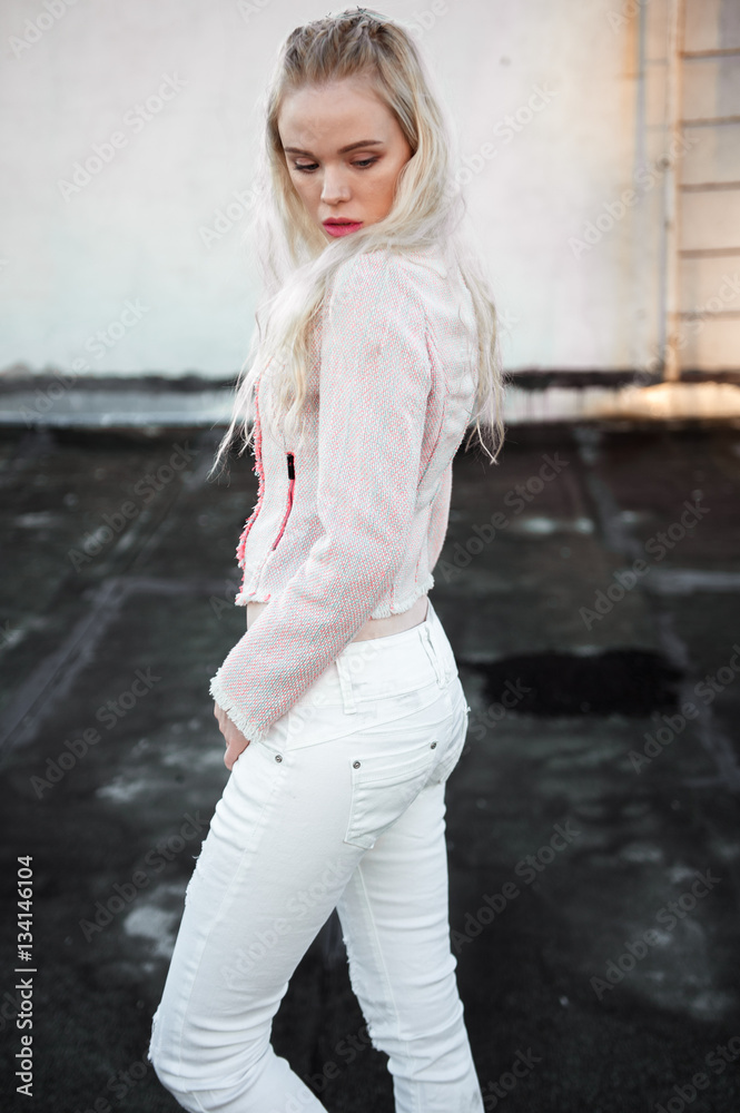 Outdoor portrait of young beautiful happy blond european lady posing on street. Model wearing stylish clothes.. Female fashion. City lifestyle. Copy space. Outdoor portrait of young beautiful happy blond european lady posing on street. Model wearing stylish clothes.. Female fashion. City lifestyle. Copy space.
