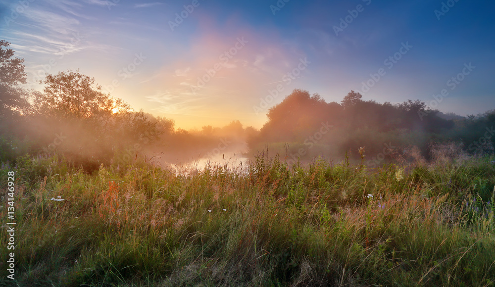 Summer misty sunrise on the river. Foggy river in the morning. P