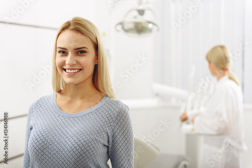 Satisfied woman leaving dental room