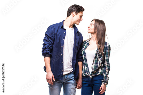 Young couple in love look each other on white.