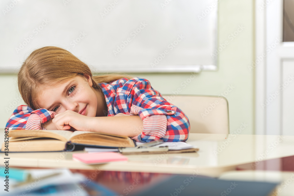 Girl with tired smile in classroom Girl with tired smile in classroom