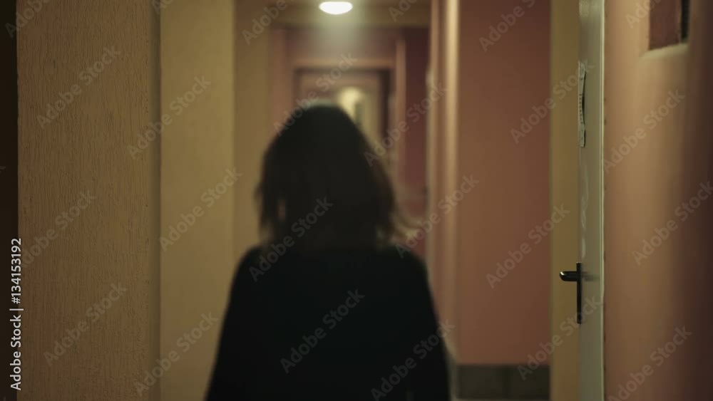 young woman walking on a hotel corridor and is attacked by a kidnapper