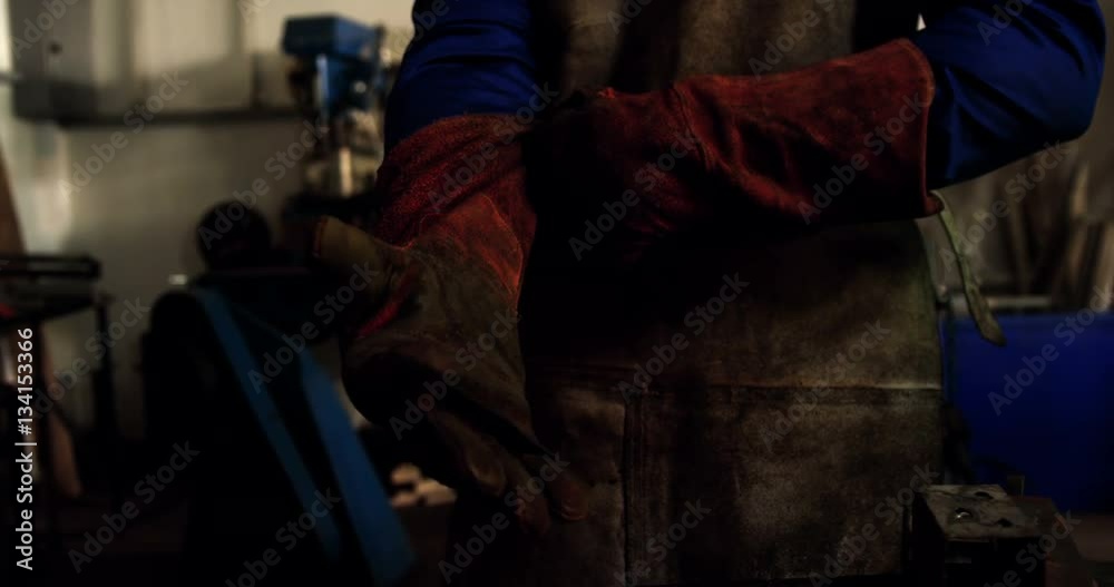 Welder holding welding torch Welder holding welding torch