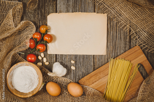 Baking or cooking ingredients background. Top view photograph with kitchen utensils on vintage, natural, raw, wooden background with visible texture.