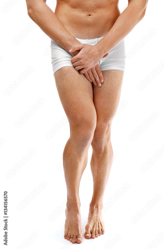 Medical concept. Closeup of man in boxers with health problem on white background