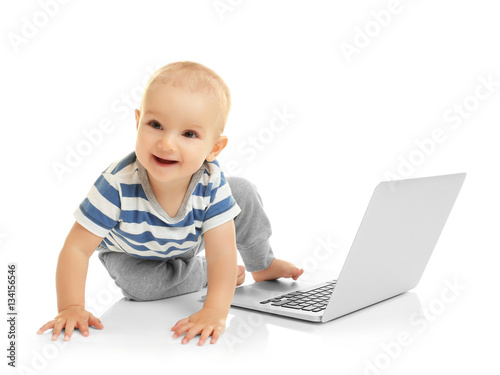 Cute baby boy with laptop o...