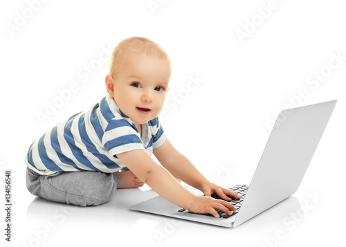 Cute baby boy with laptop o...