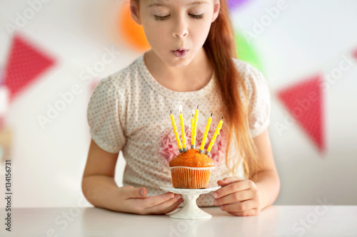 Cute little girl blowing ou...