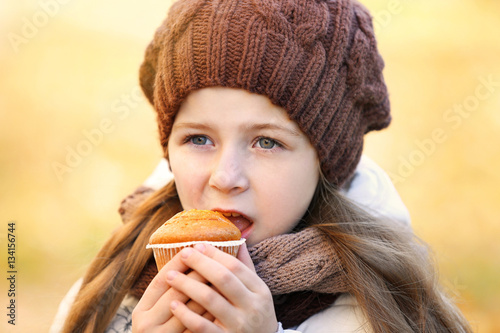 Cute little girl eating tas...