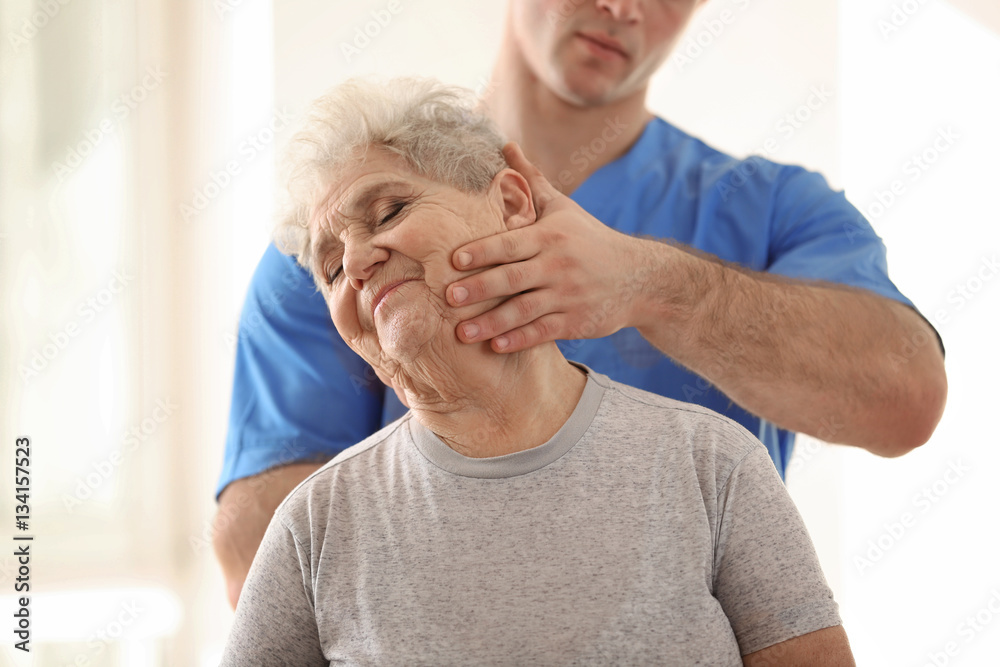 Physiotherapist working with elderly patient in clinic Physiotherapist working with elderly patient in clinic